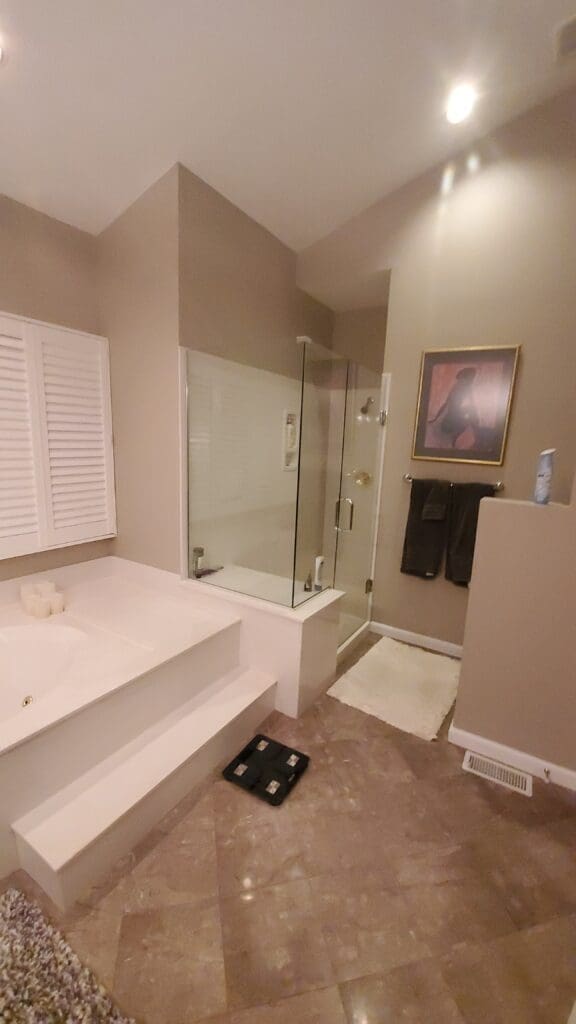 Remodeled bathroom with a glass shower and soaking tub