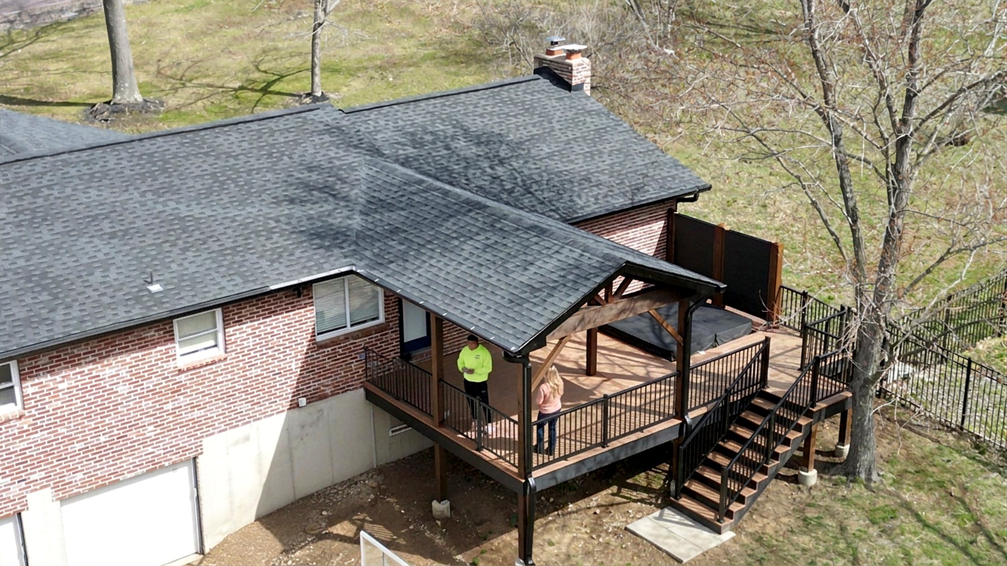 Aerial view of a covered deck with stairs to the yard