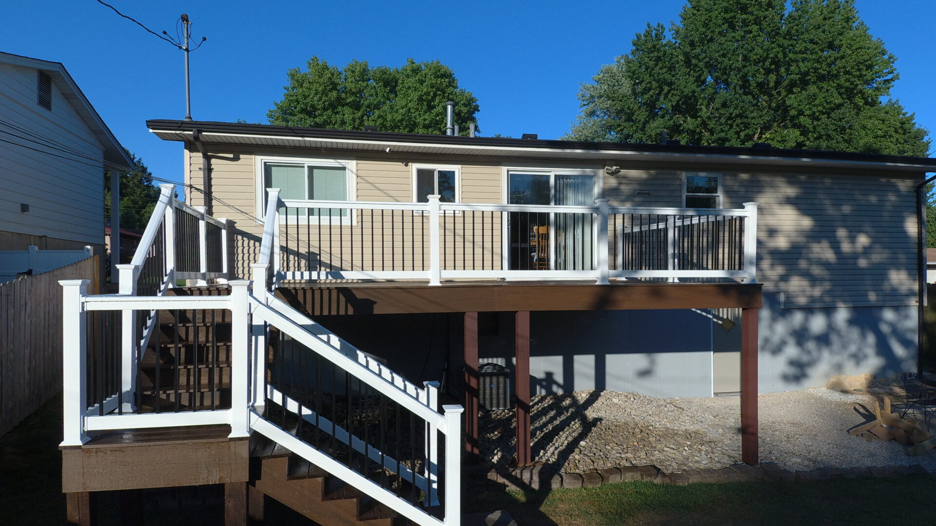 Raised deck with dual stairs and white rail