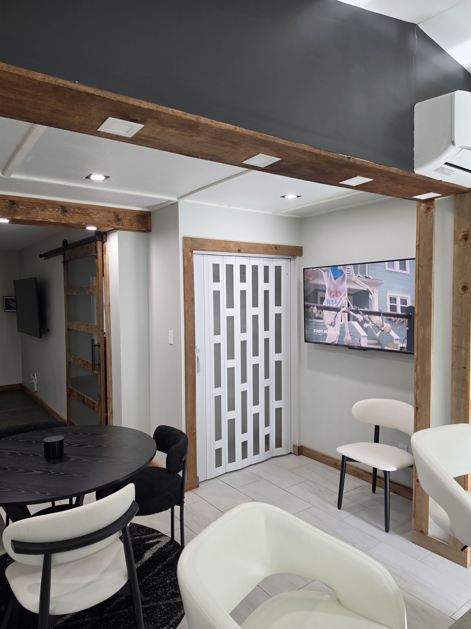 Dining area with a decorative white door and a sliding barn door