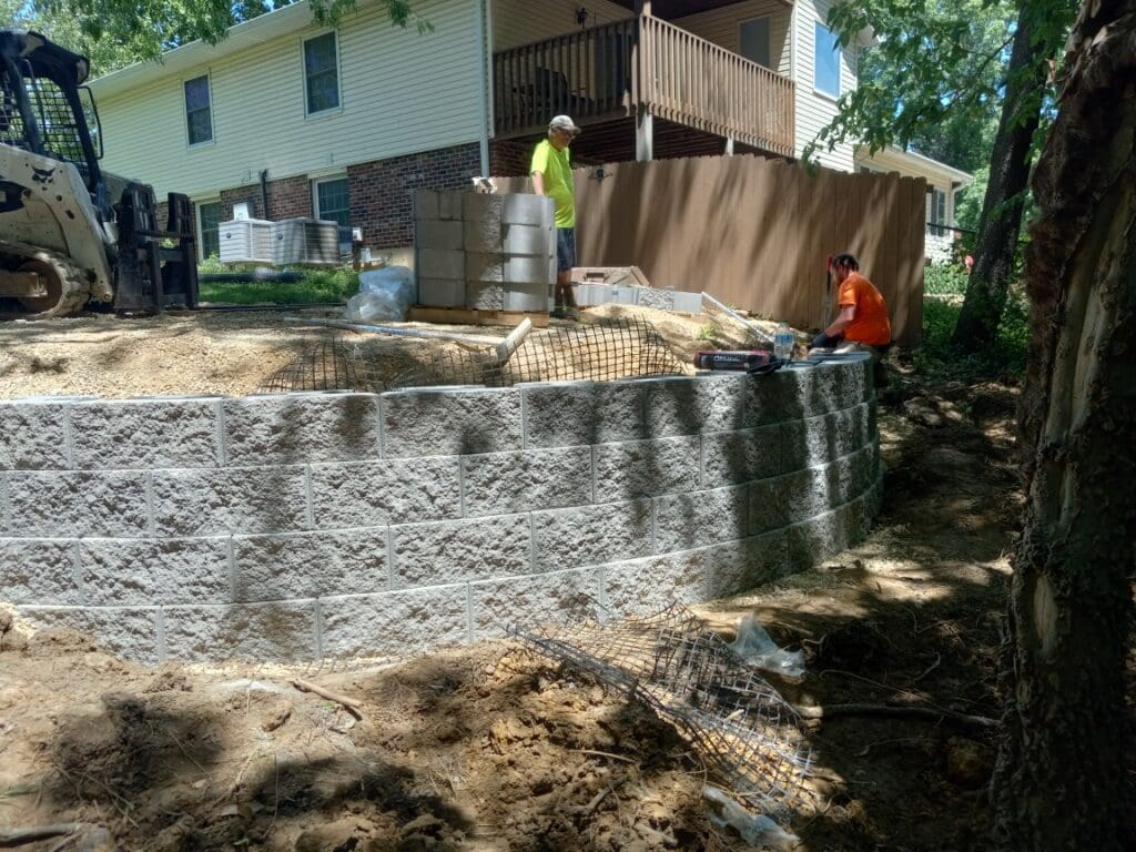 Crew building a block retaining wall